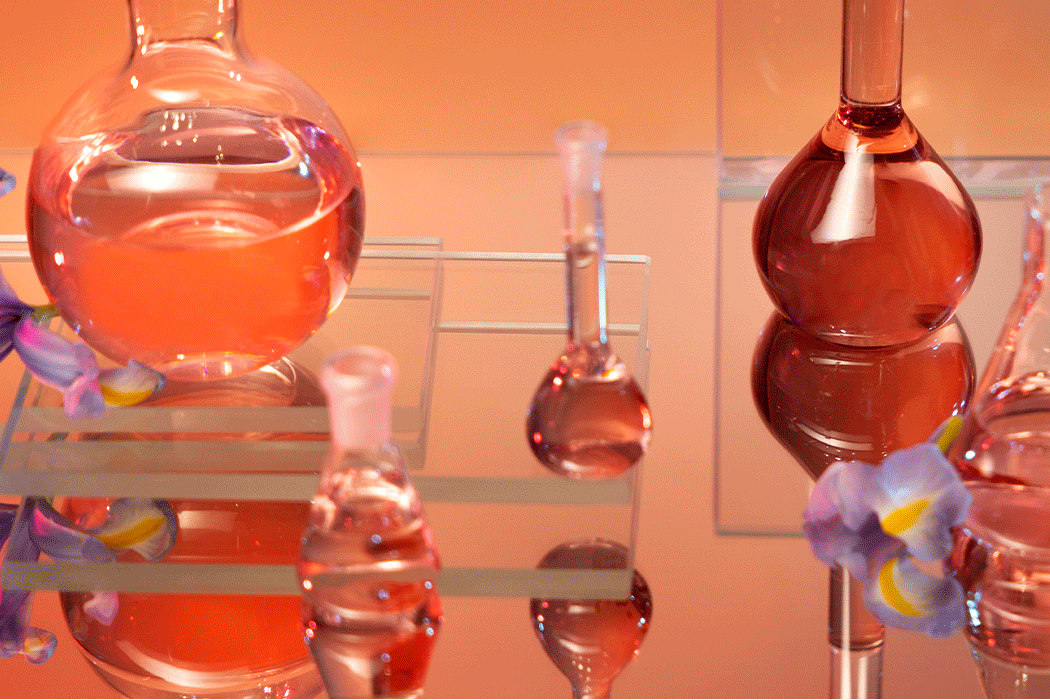 Laboratory glassware with liquid on an orange background